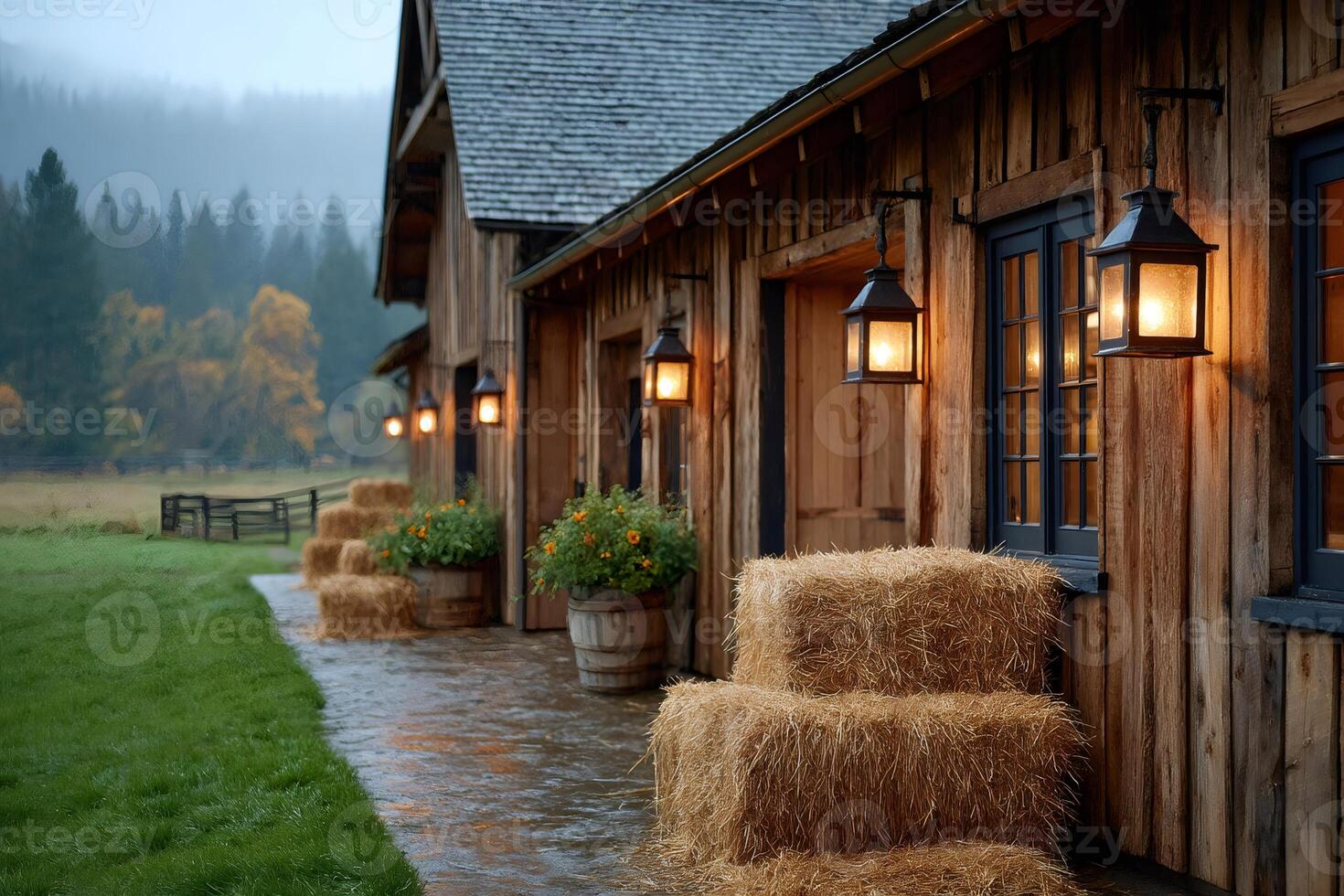 Cozy wooden barn illuminated by warm lights on a rainy autumn day photo