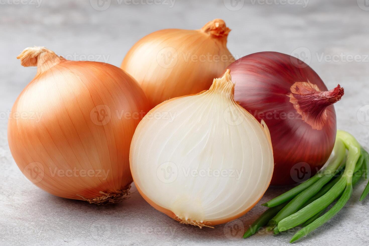 Fresh onions and green onions displayed on gray table photo