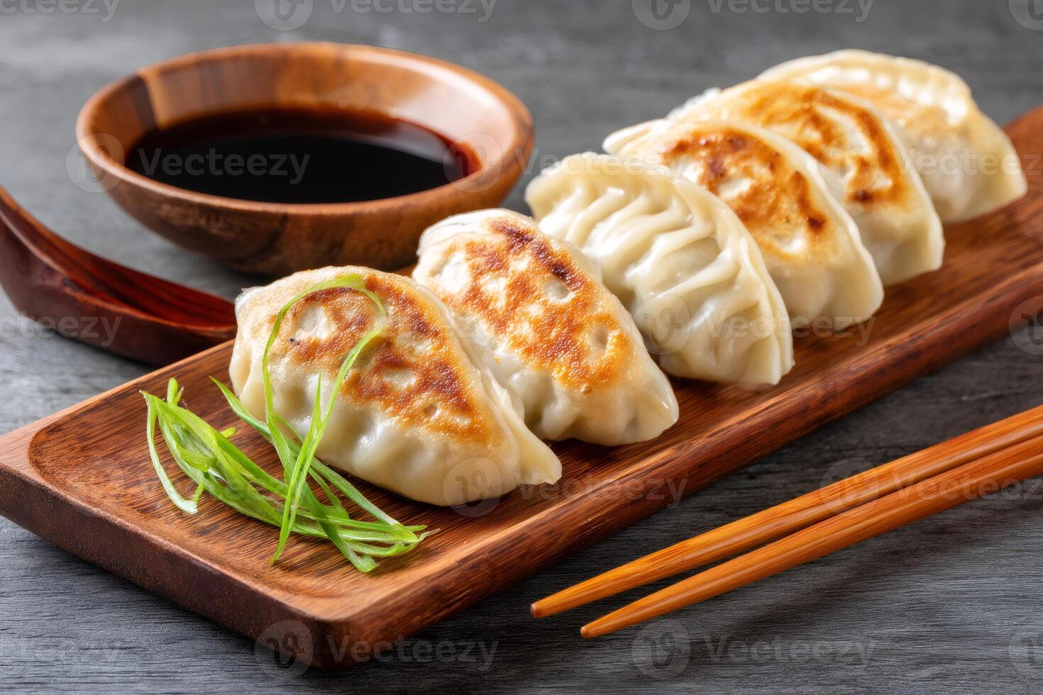 Crispy fried dumplings gyoza pot stickers with soy sauce and chopsticks photo