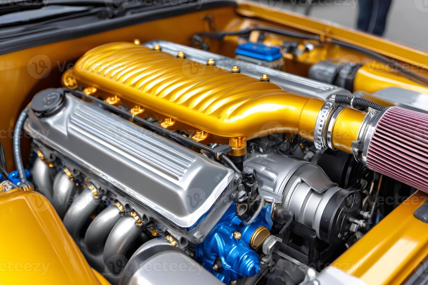 Powerful customized car engine showing gold intake manifold and air filter photo