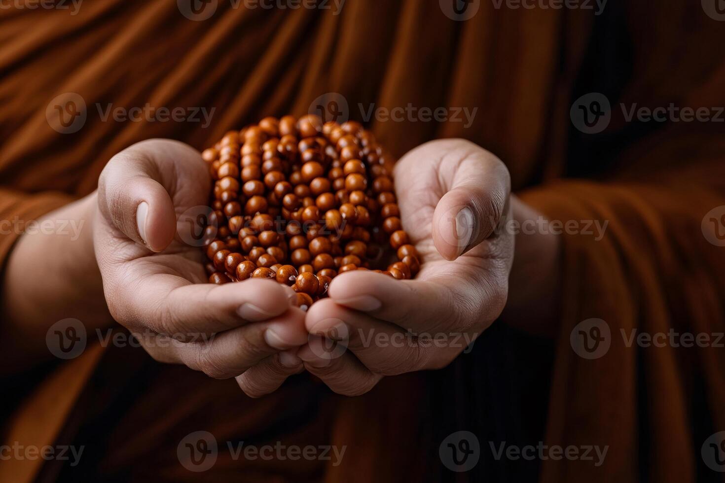 Monk holding prayer beads in open palms, embracing spirituality photo