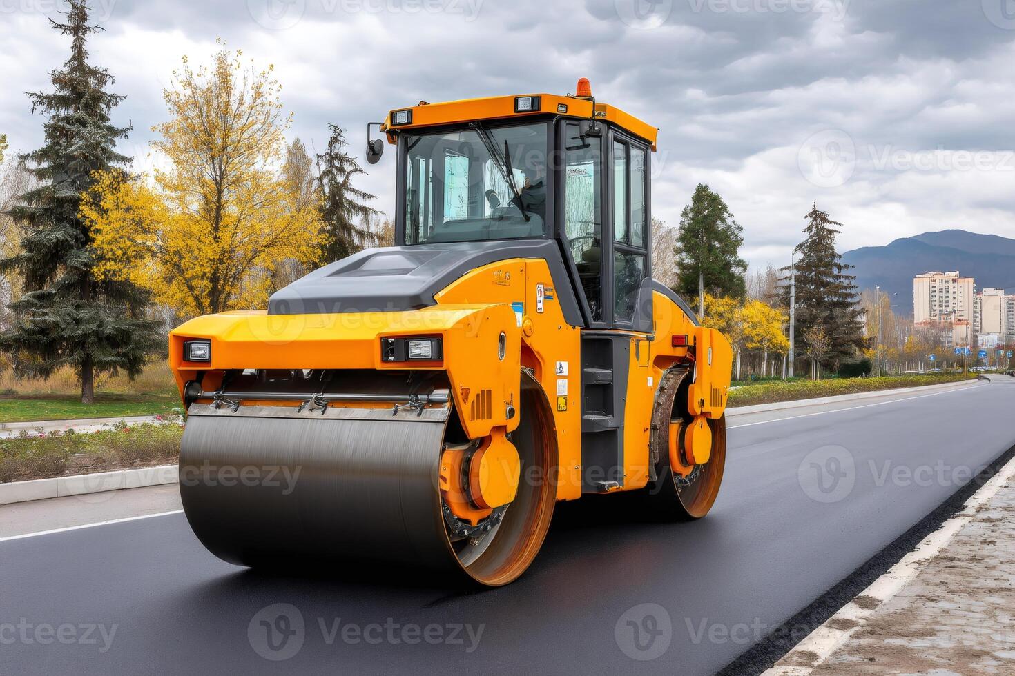 Road roller flattening fresh asphalt on a city street.. photo