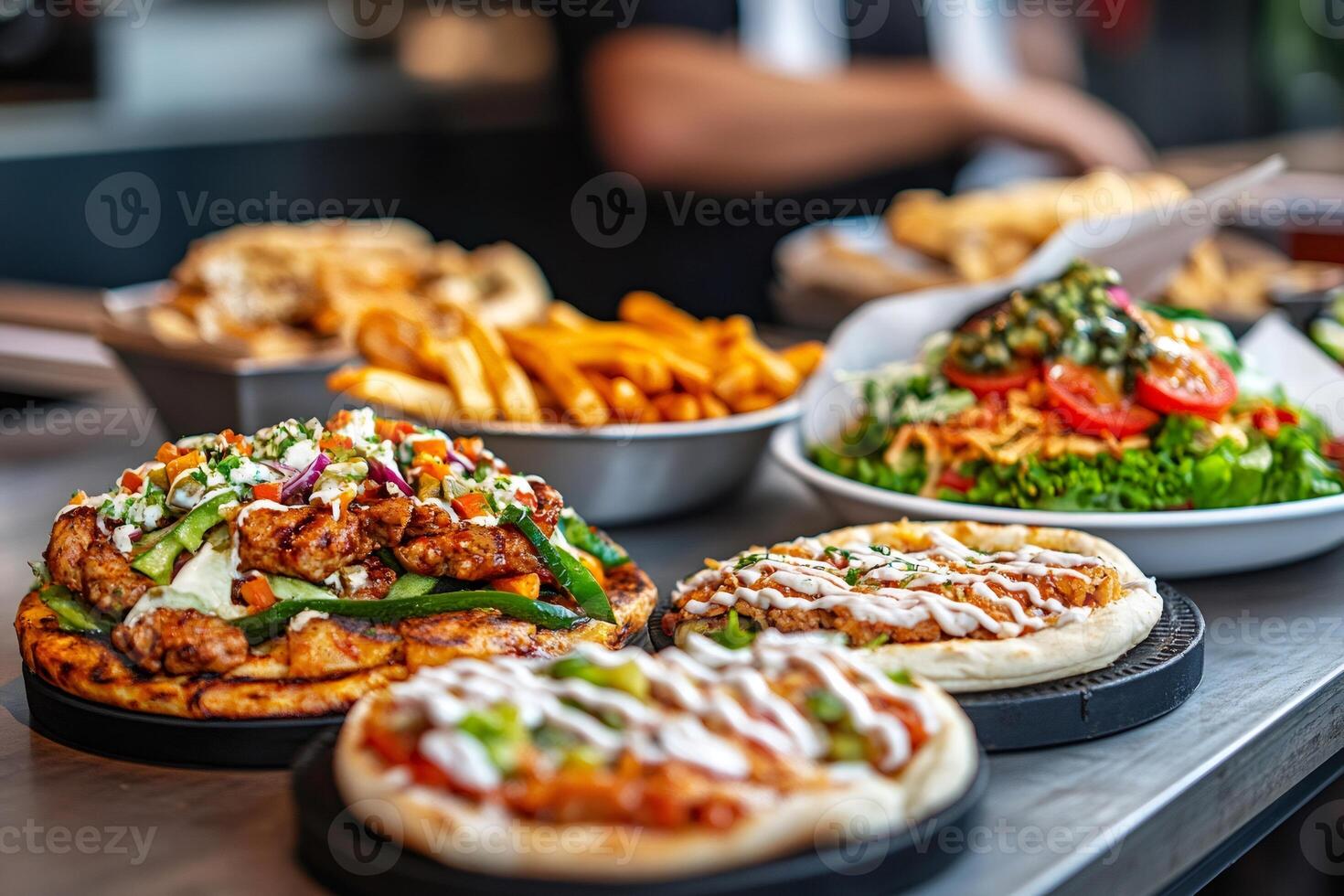 Delicious chicken shawarma pitas with fresh vegetables and fries being prepared in restaurant kitchen photo