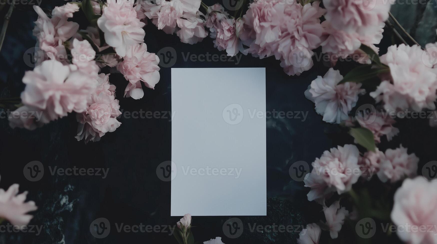 A blank piece of paper surrounded by pink flowers photo