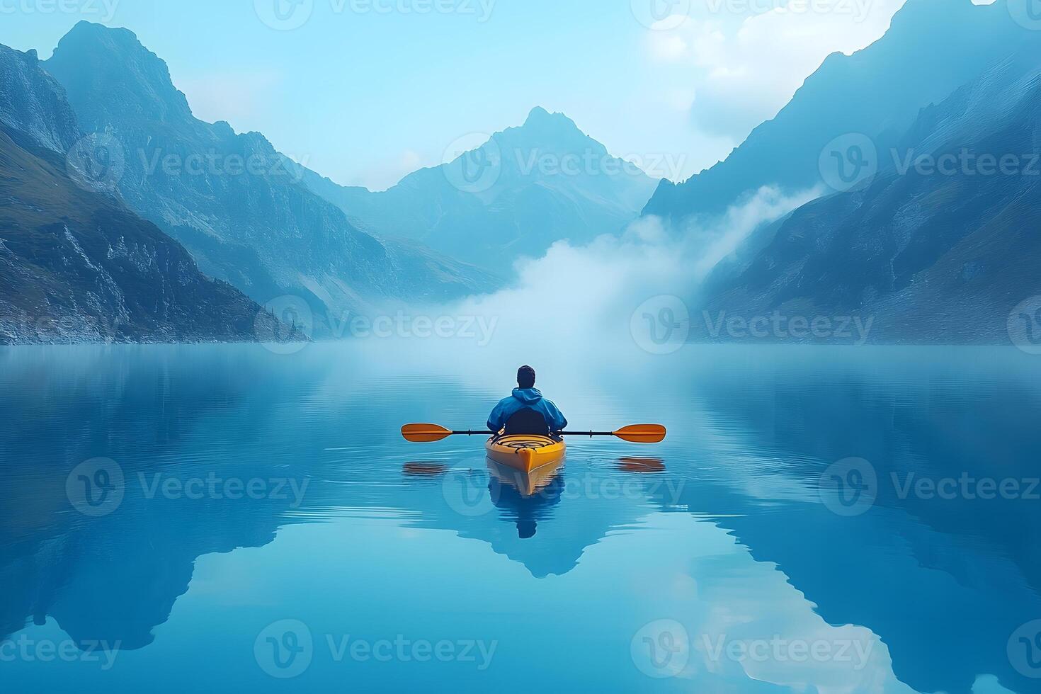Serene Kayaking Adventure in Misty Mountain Lake for Outdoor Exploration and Tranquility photo