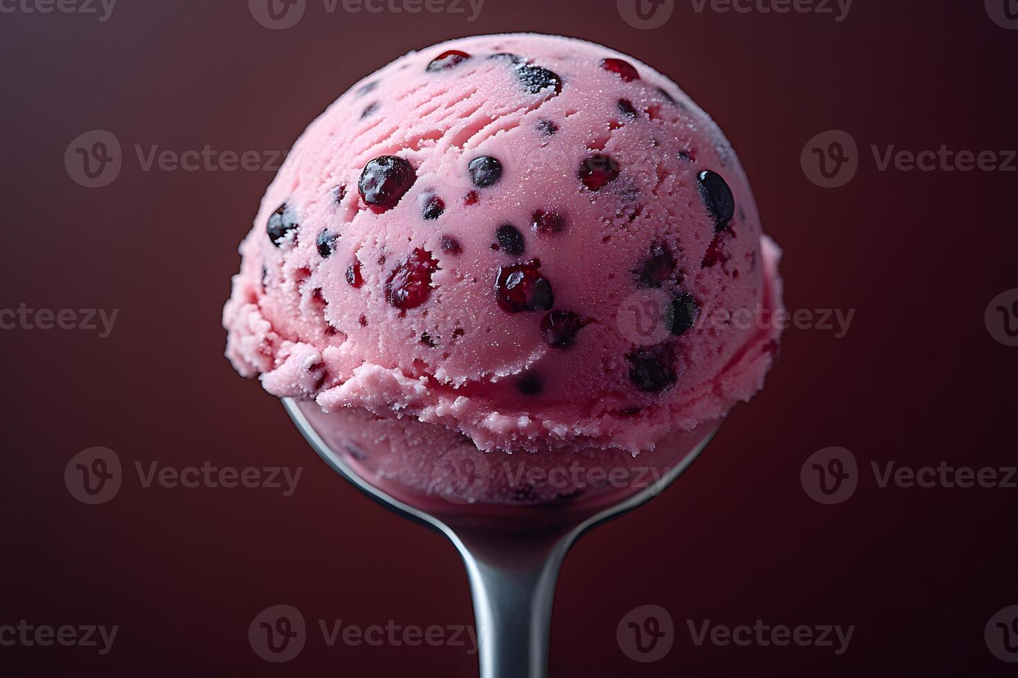Delicious Berry Ice Cream Scoop on a Spoon Against Dark Background photo