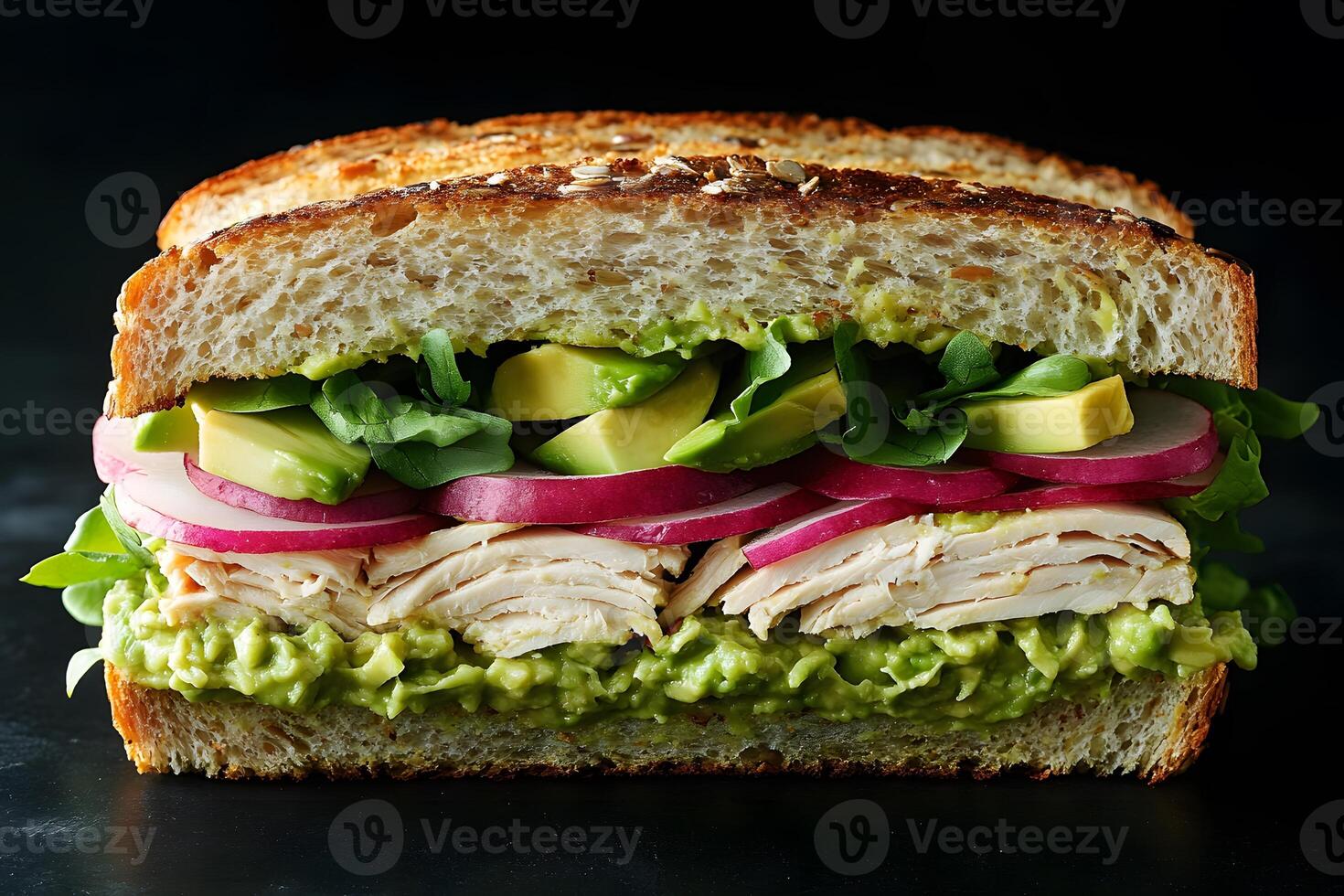 Fresh Turkey and Avocado Sandwich with Arugula and Pickled Onions on Whole Grain Bread photo