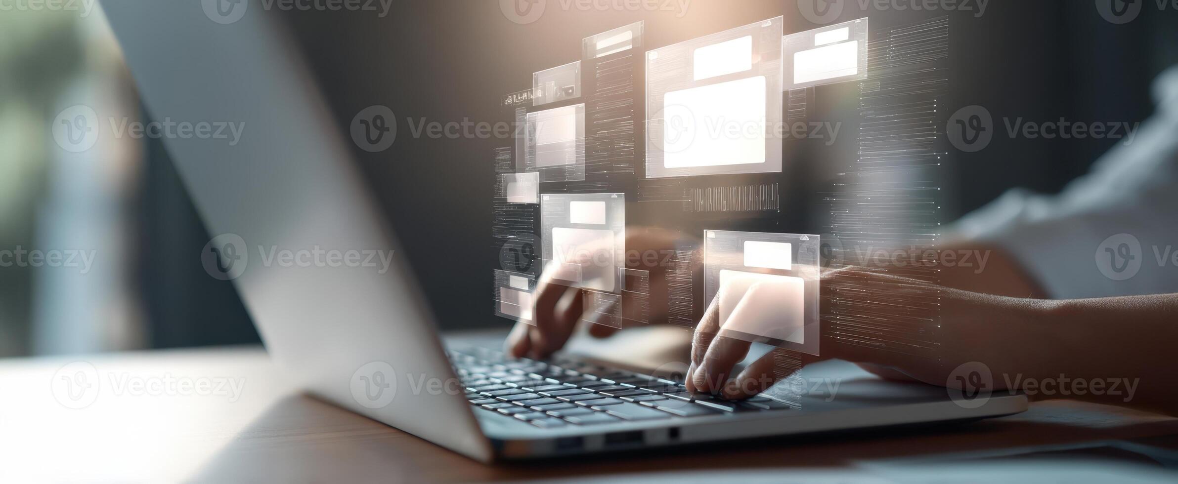 The laptop displaying digital interfaces with hands typing on the keyboard. photo