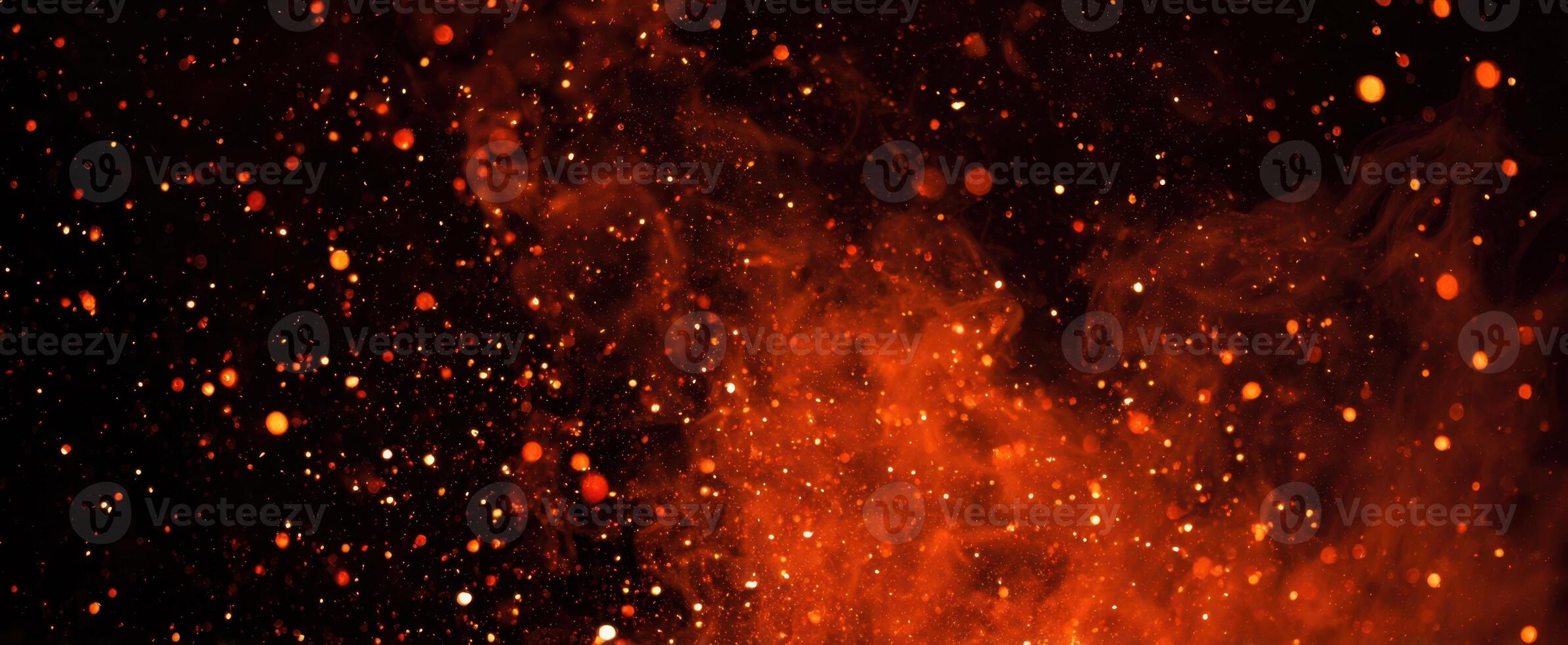 The vibrant explosion of fiery particles against a dark background. photo