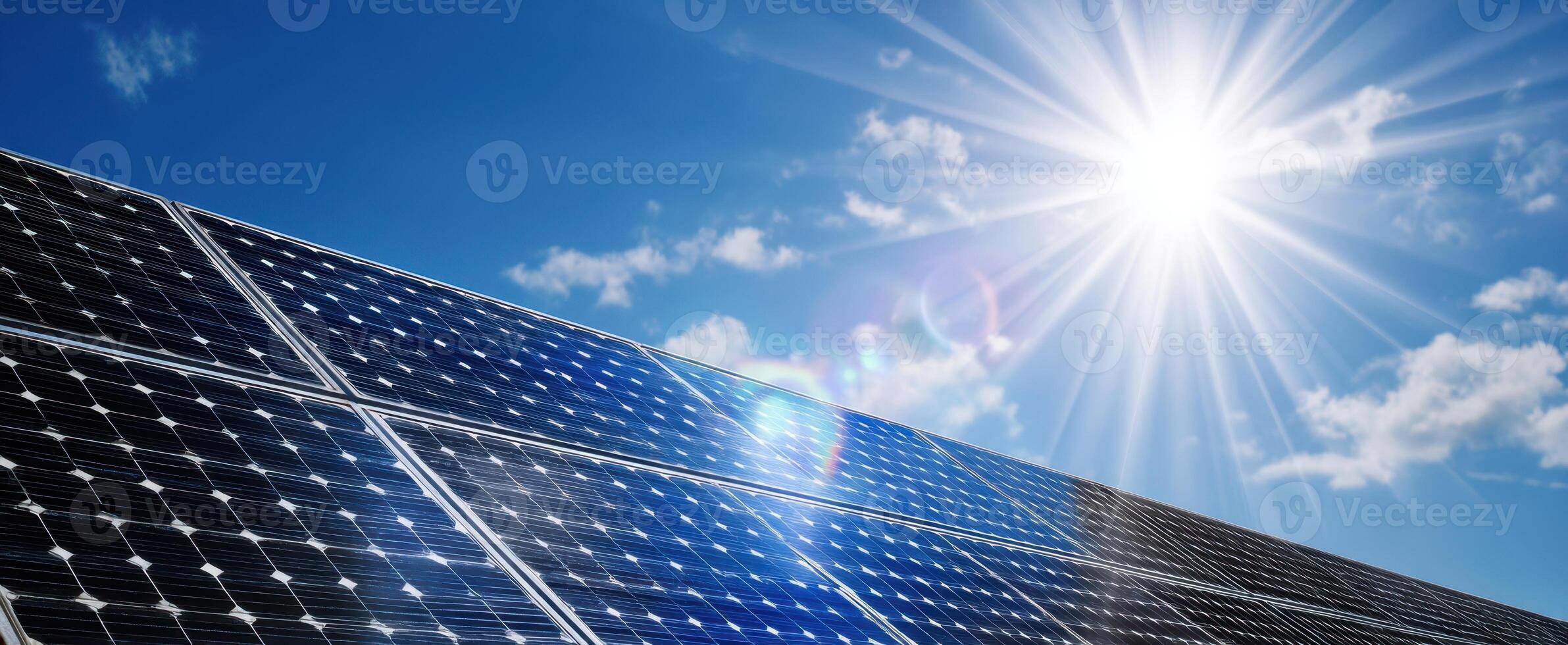 The solar panels absorbing sunlight in a bright blue sky with clouds photo