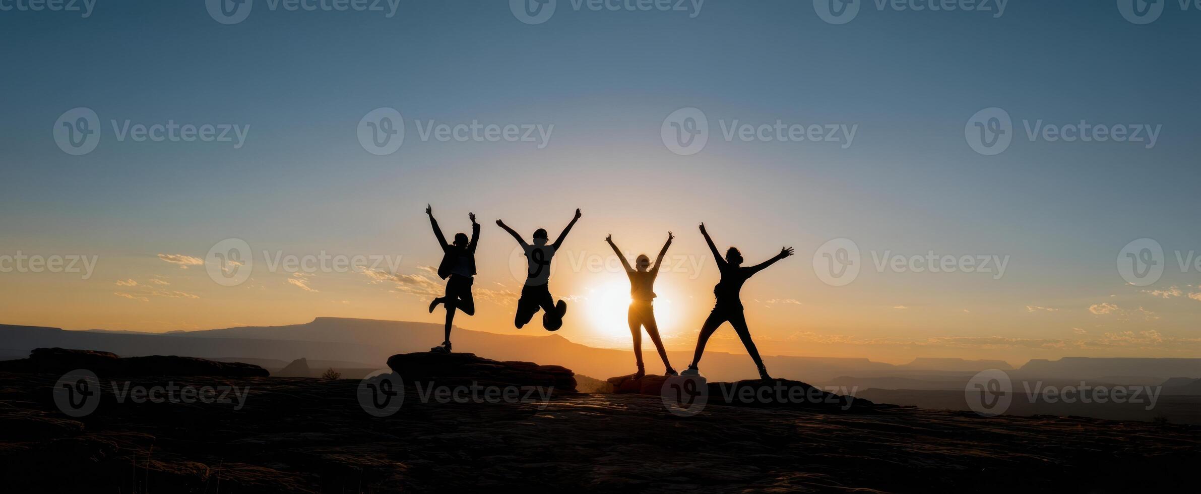 The joyful group celebrating life at sunset in a breathtaking landscape. photo