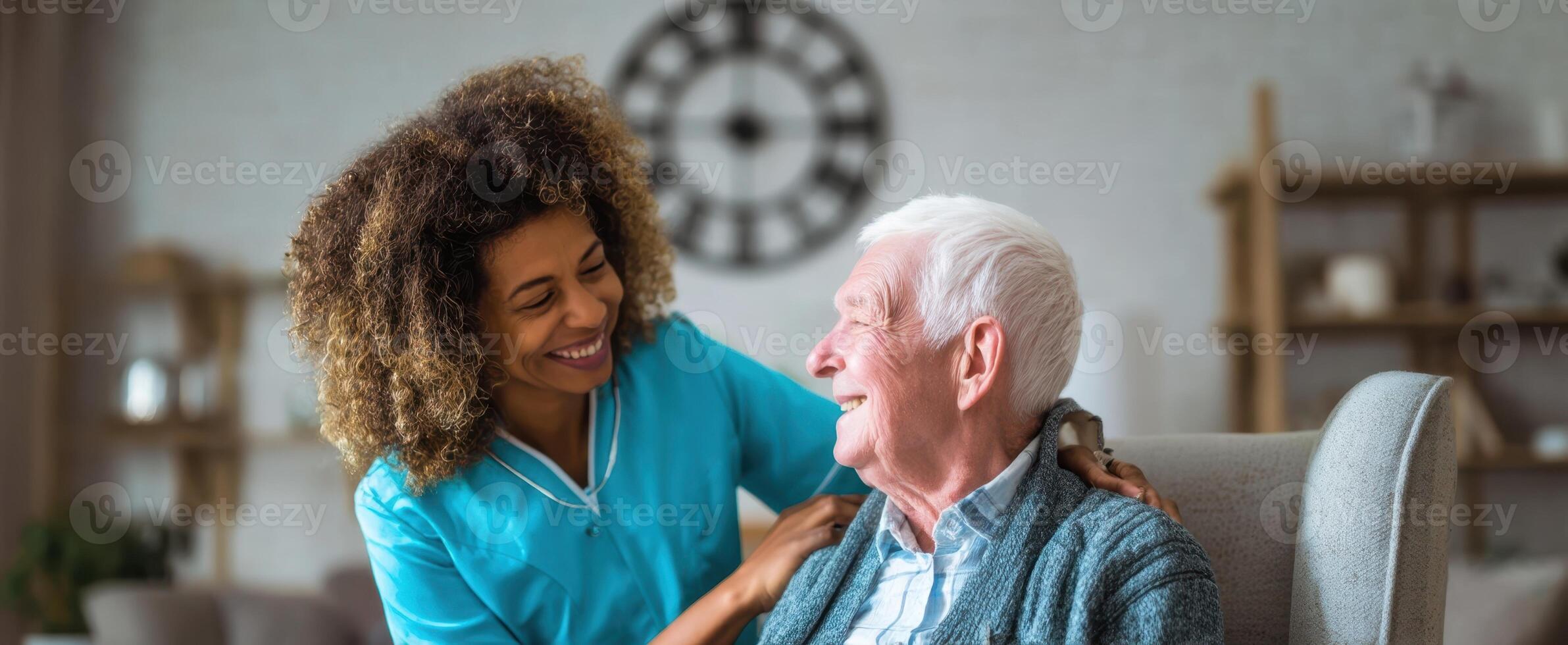 The elderly man enjoying a warm conversation with his caregiver in a cozy home setting. photo
