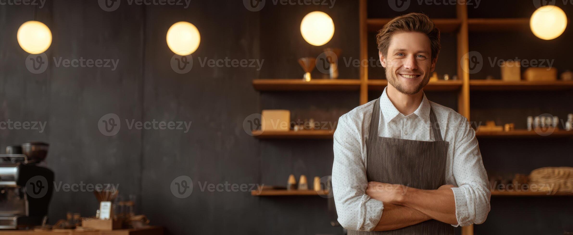 A smiling man in an apron standing in front of a coffee shop photo