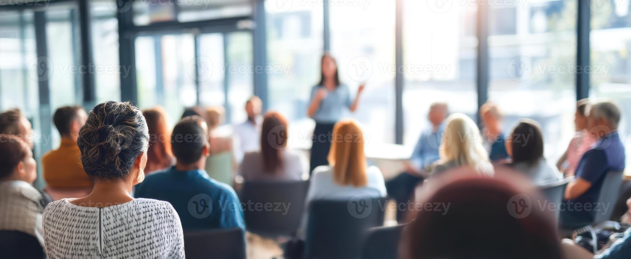 The engaged audience listening to a speaker during a professional seminar. photo