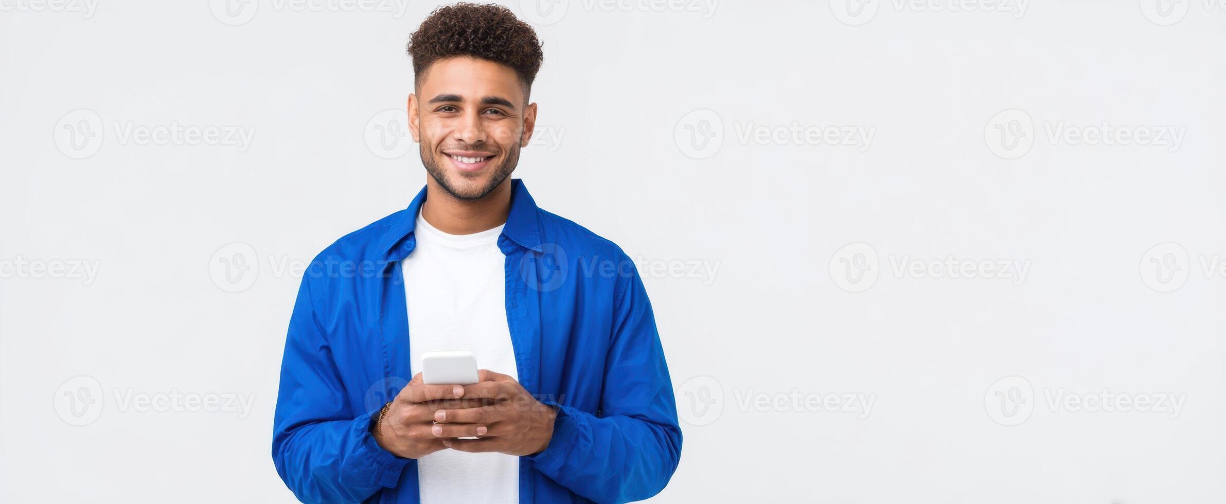 The smiling man with a smartphone in a casual blue jacket. photo