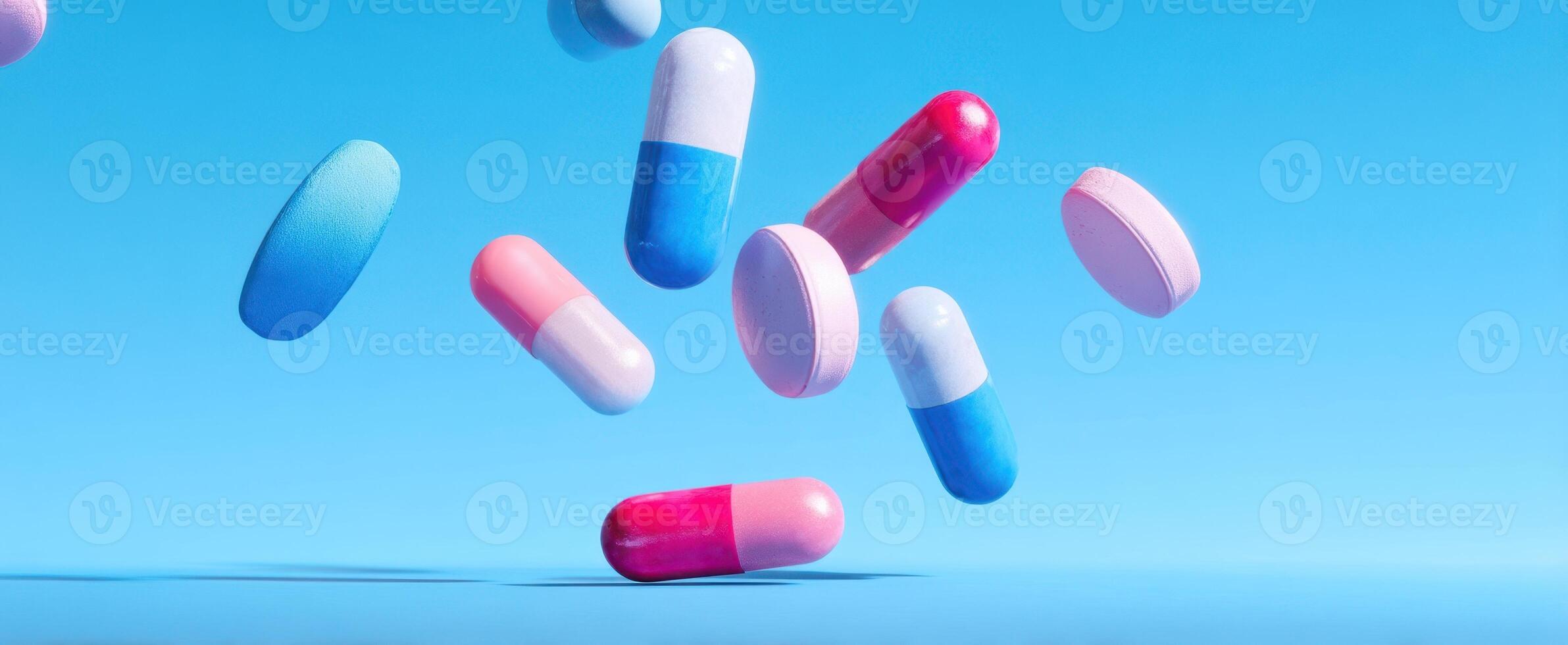 The colorful capsules floating against a bright blue background. photo