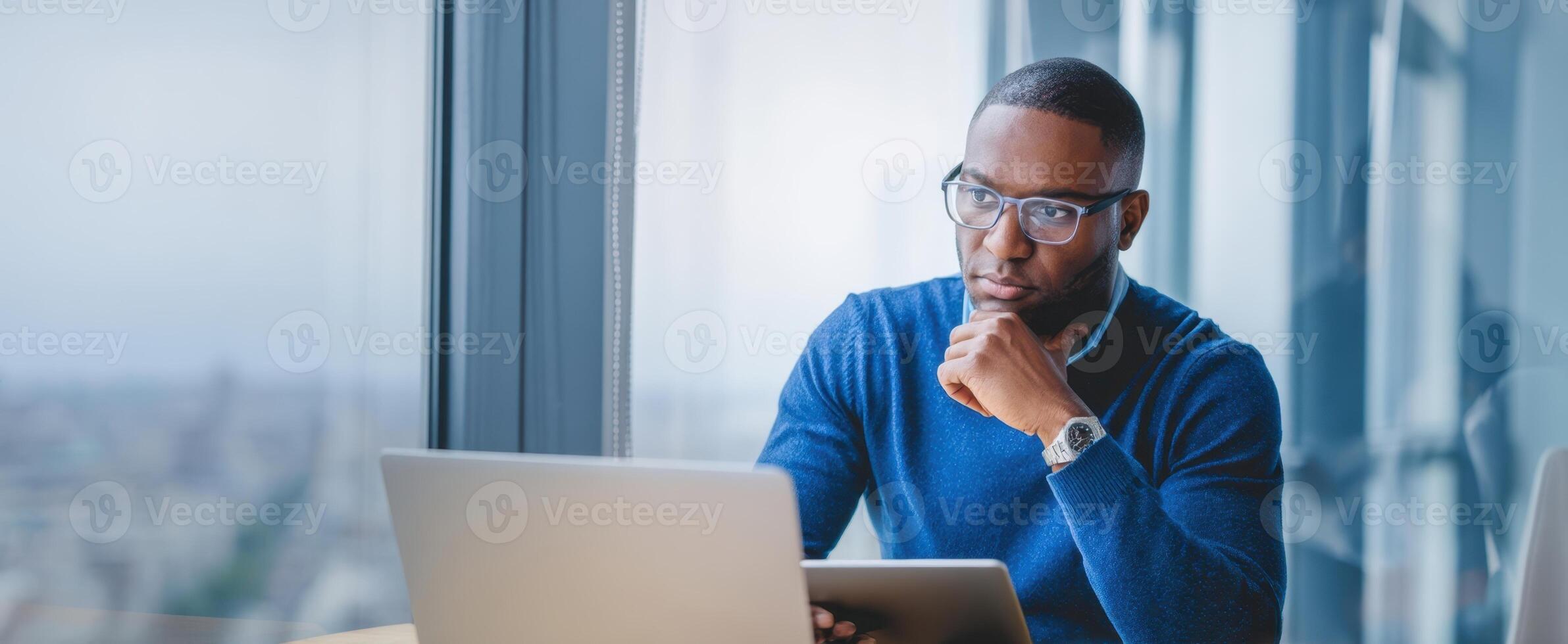 The thoughtful businessman engaged with technology in a modern office setting. photo