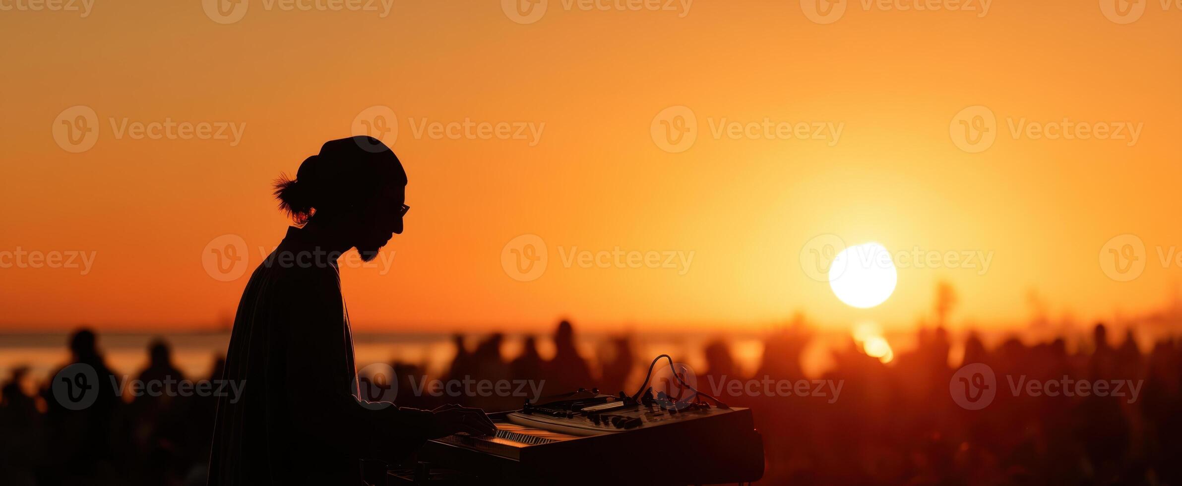 The musician creating enchanting sounds against a stunning sunset backdrop. photo