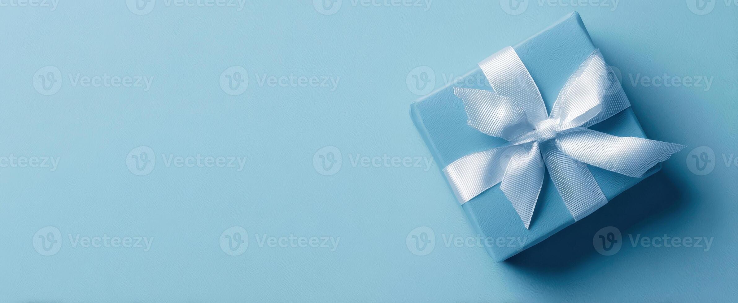 The Elegant Blue Gift Box with a White Ribbon on a Soft Background photo
