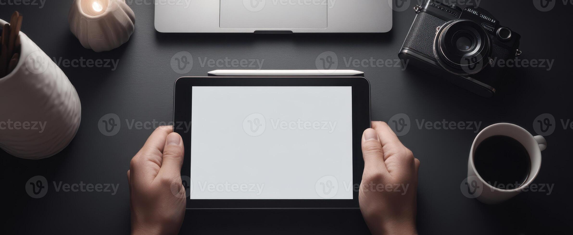 The tablet in hands showcasing a modern and minimalist workspace setup. photo