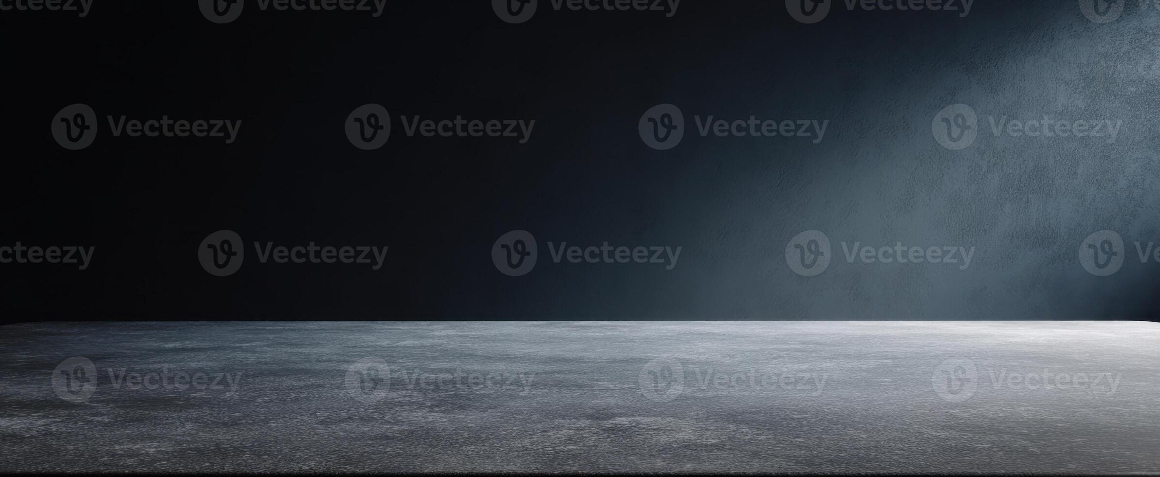 The empty concrete surface illuminated by soft dramatic light in a dark space. photo