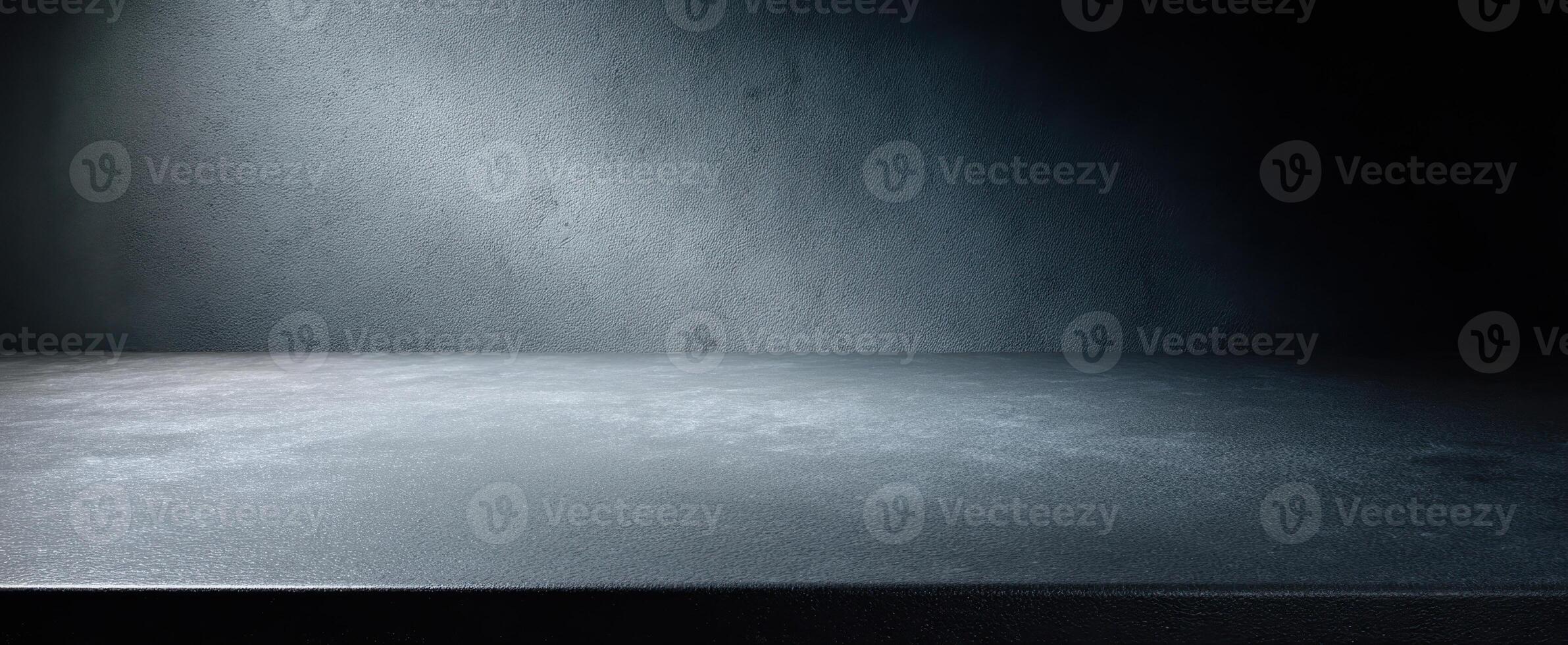 The textured dark surface illuminated by soft light in a minimalist setting photo