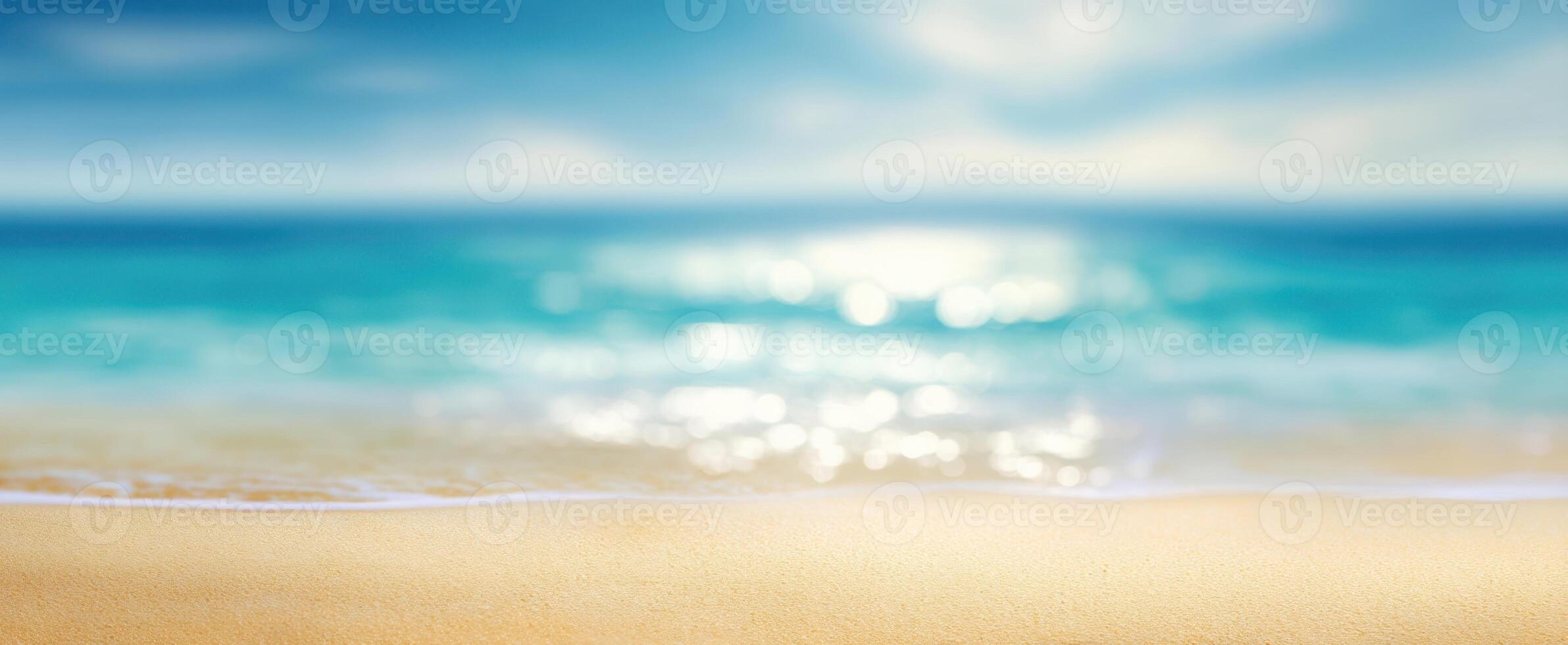 The tranquil beach with gentle waves and a blurred oceanic background. photo