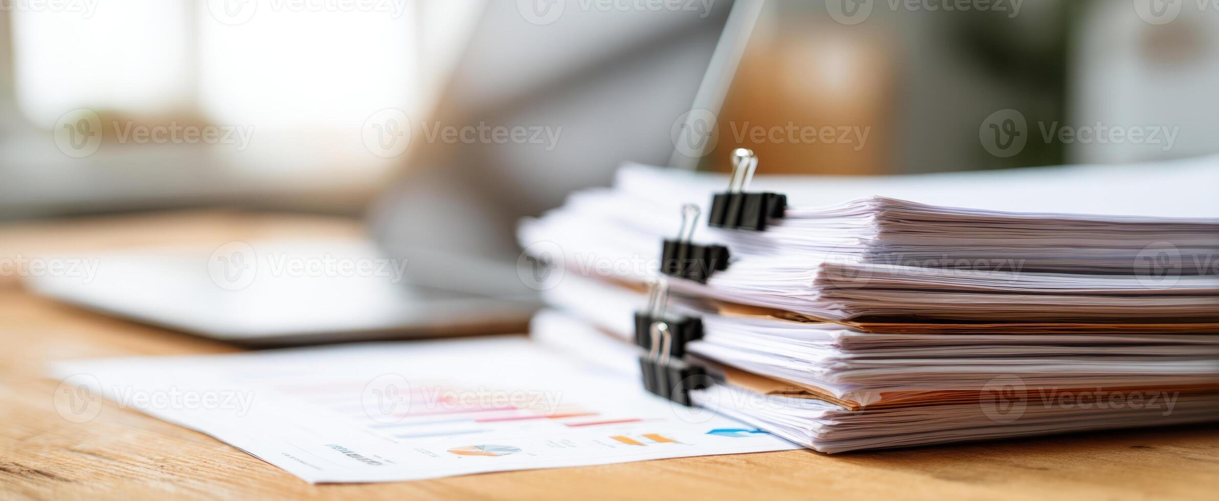 The stack of organized binders and paperwork on a modern office desk photo