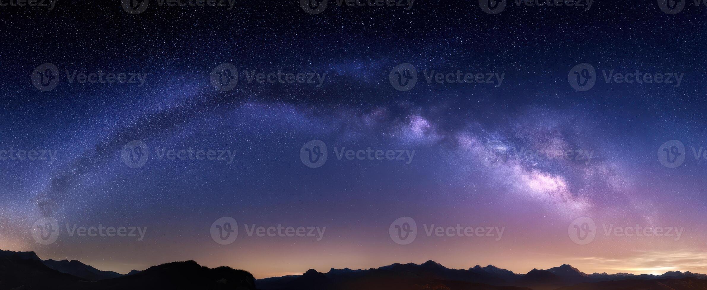 The breathtaking Milky Way arching over tranquil mountain landscape at night. photo