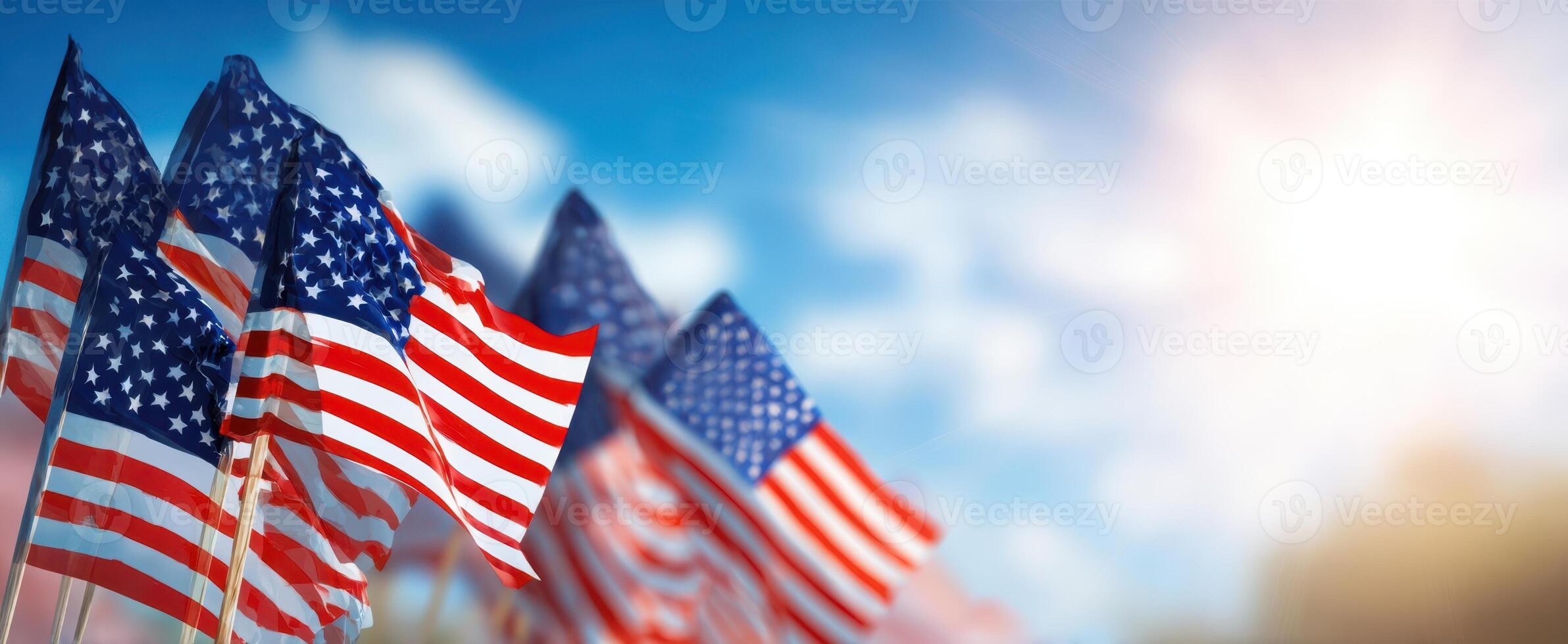 The American flags waving in the breeze against a bright sky. photo