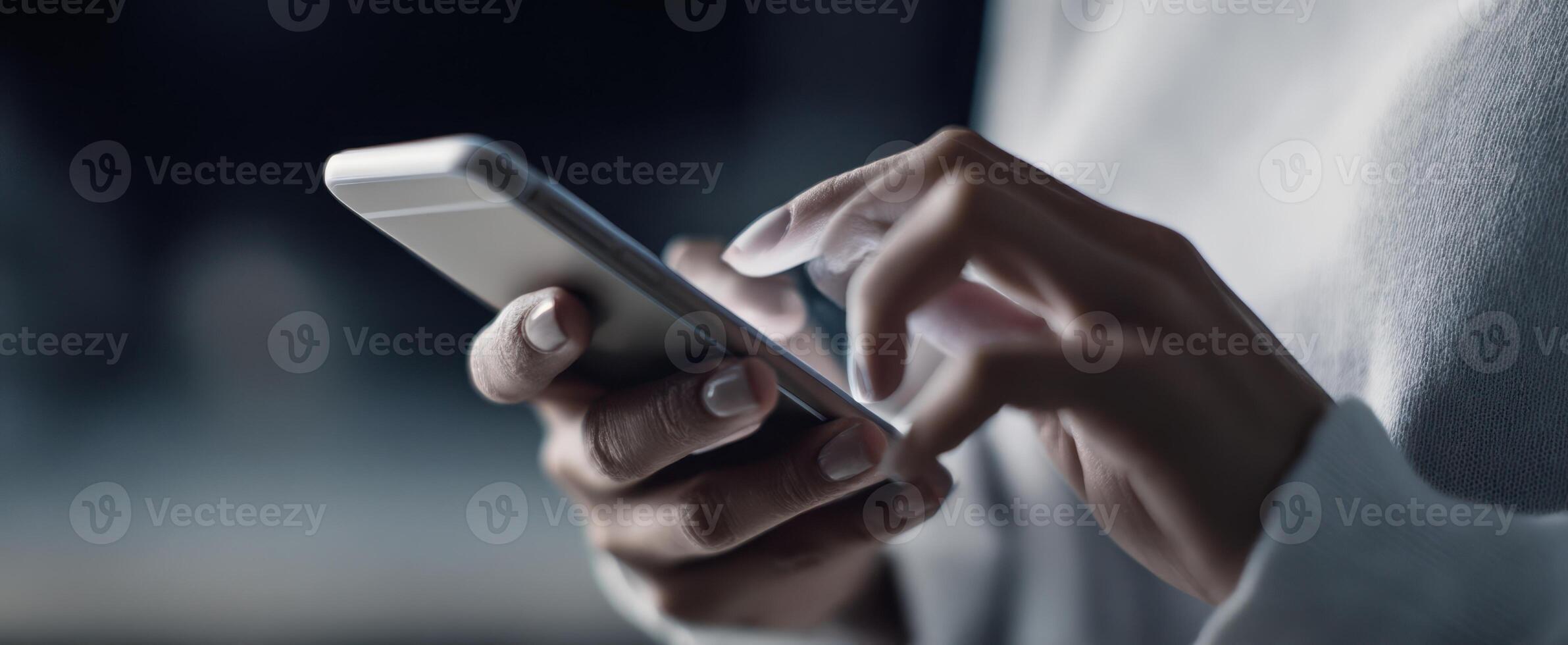 The close-up of hands interacting with a smartphone in a modern setting. photo