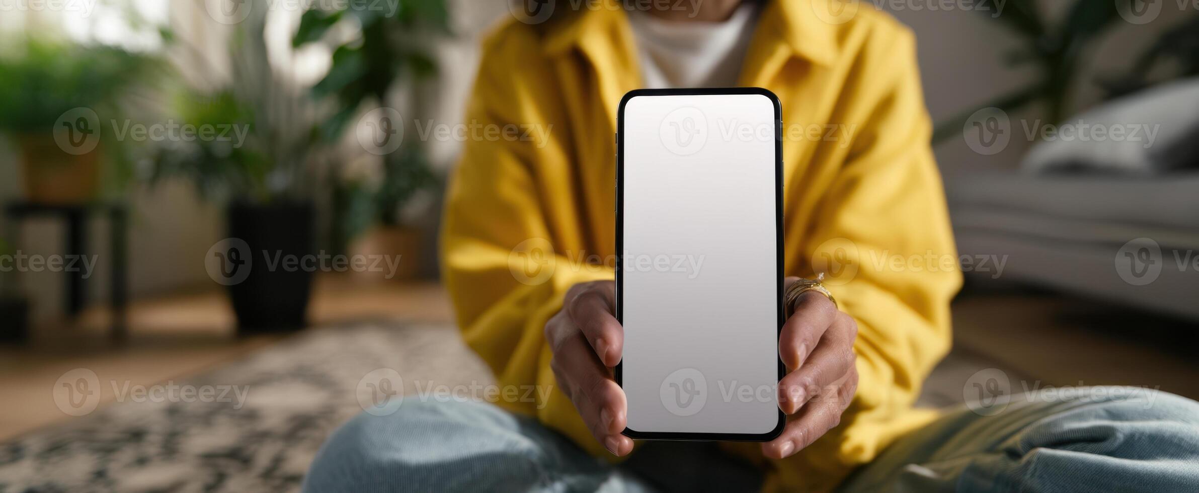 The smartphone display held by a young person in a cozy indoor setting. photo