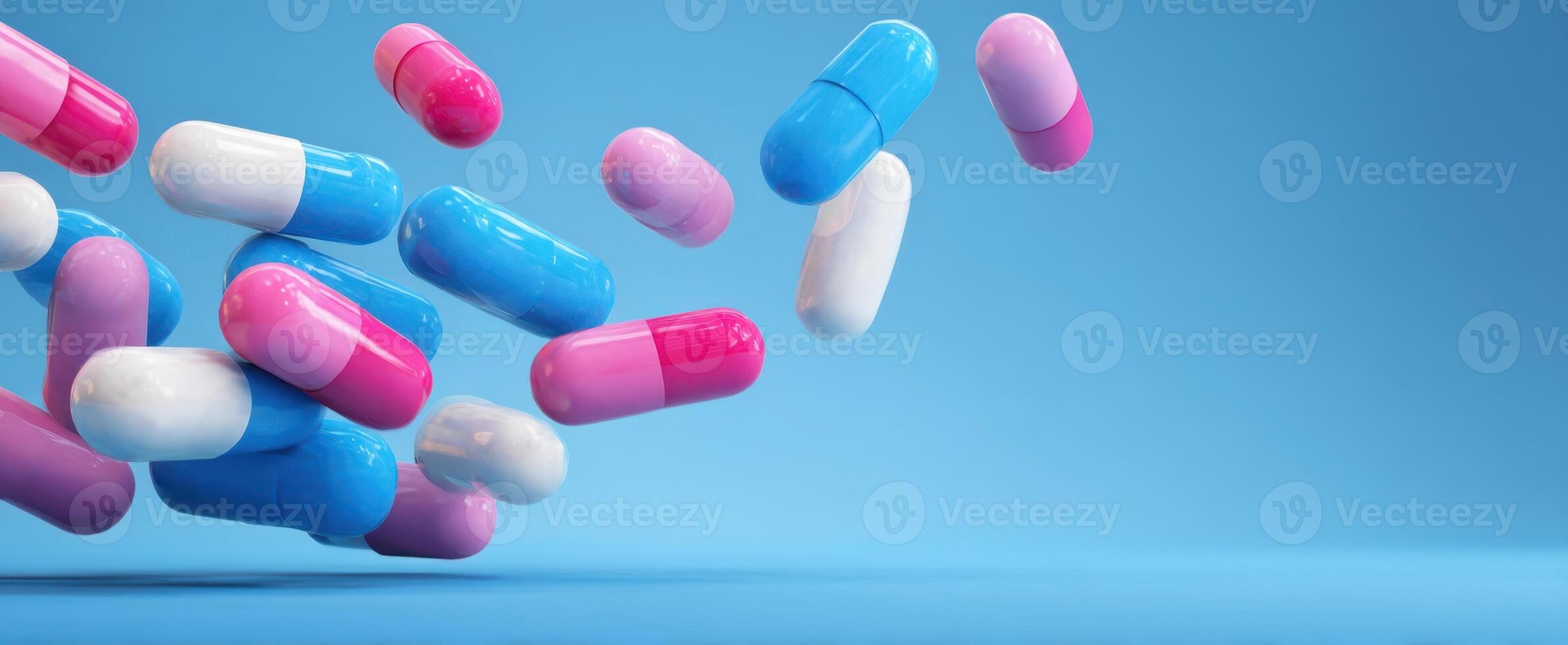 The colorful capsules floating against a blue background for health and wellness. photo