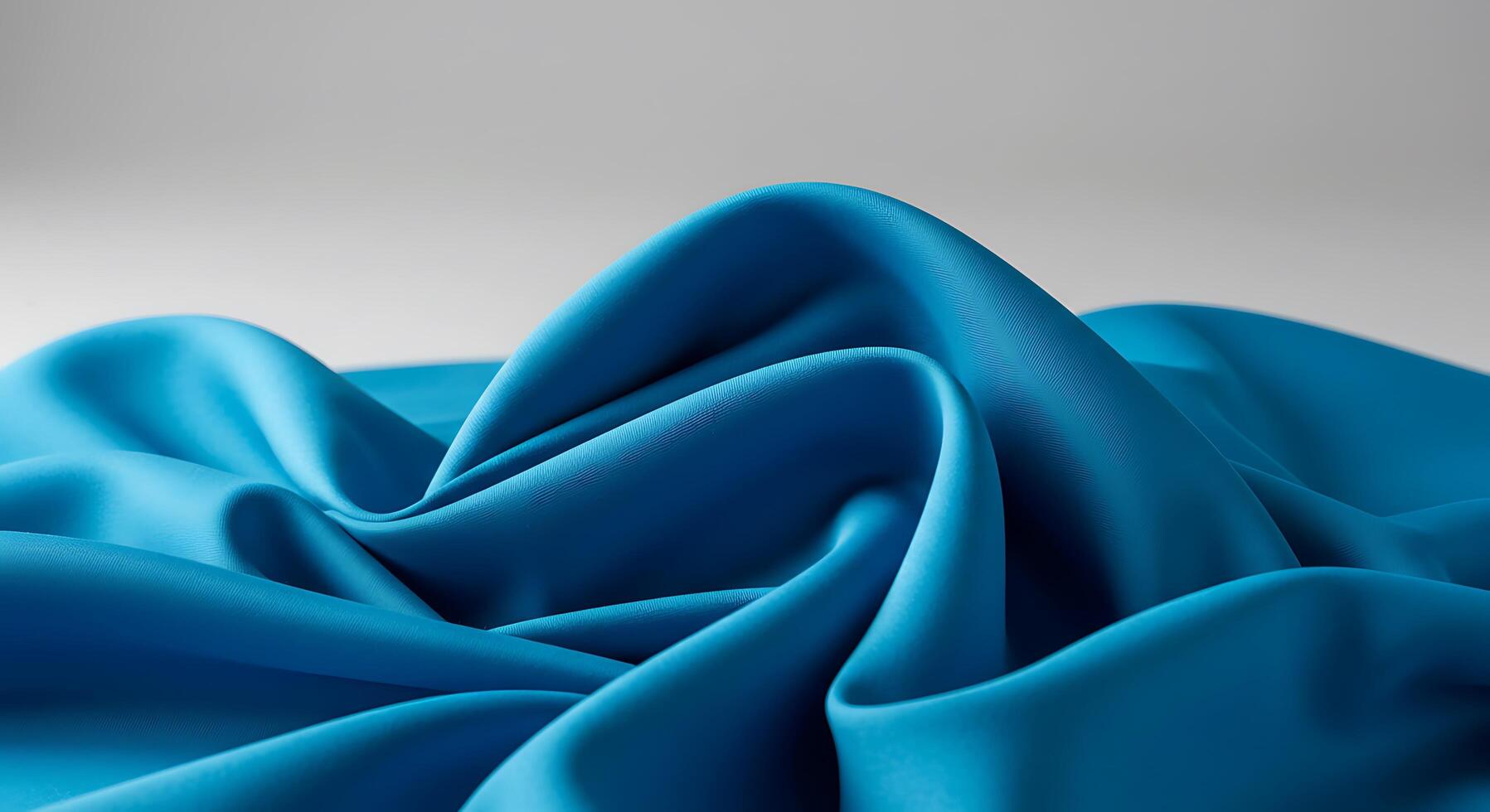 A blue satin fabric with folds photo