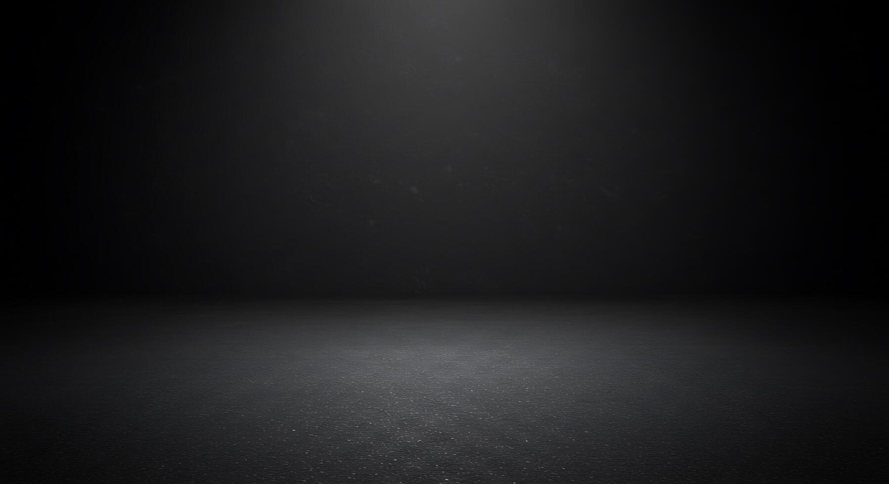 Black background with light shining from the ceiling photo