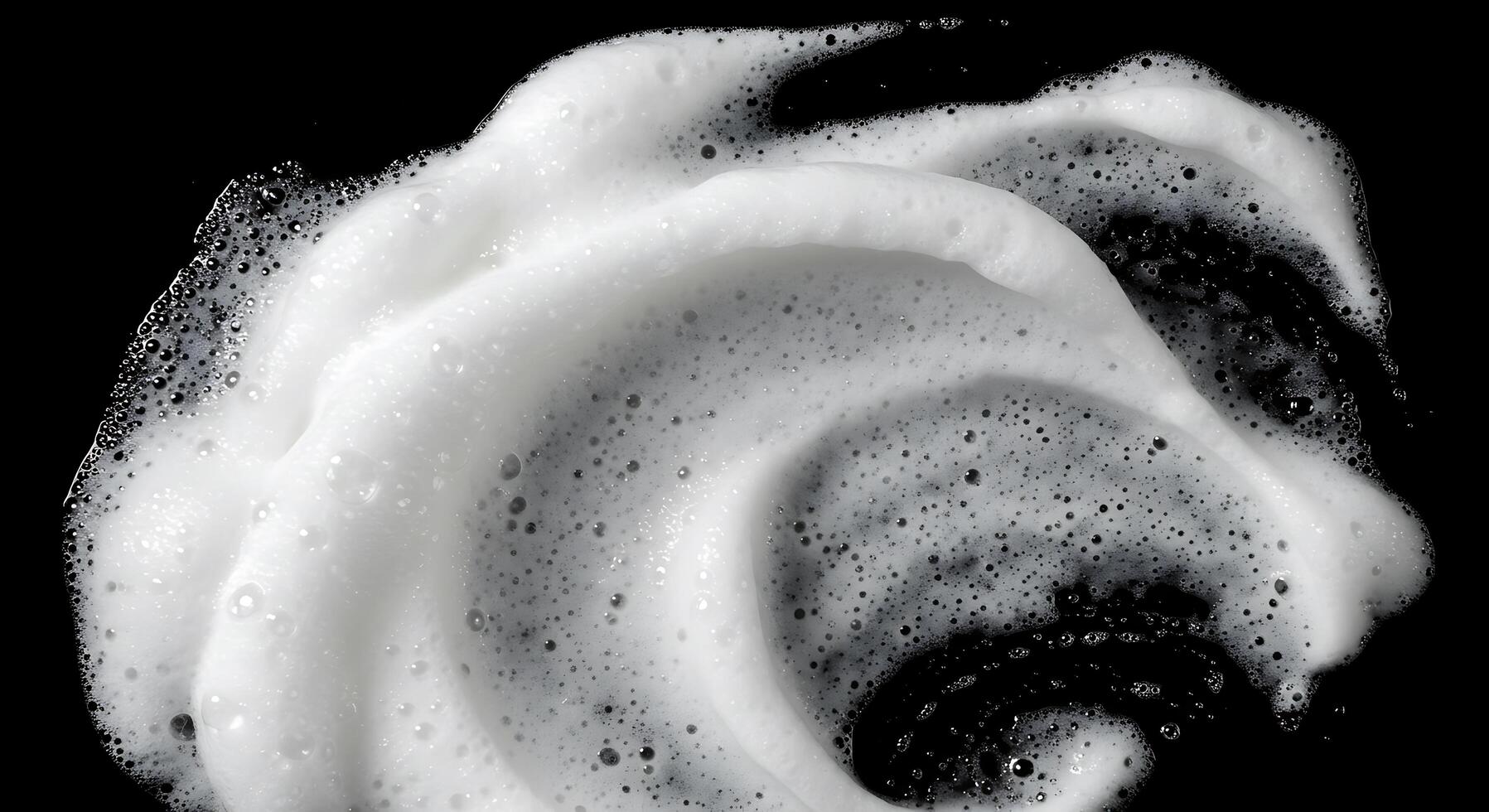 A close up of a white foam on a black surface photo