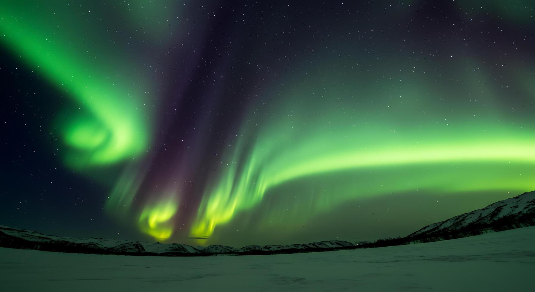 The aurora borealis is seen over the snow covered mountains photo