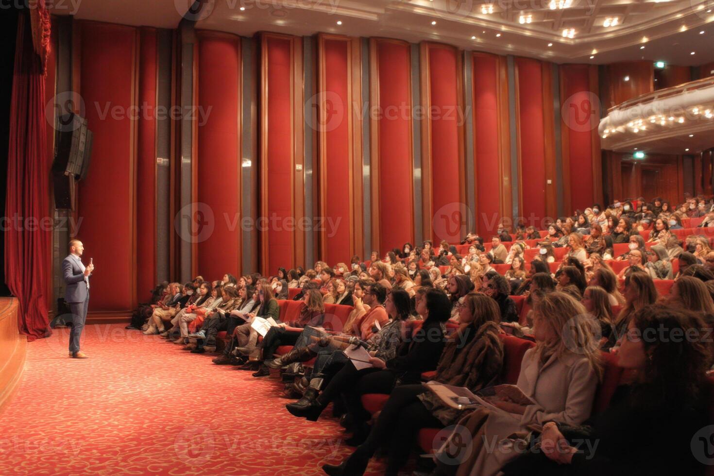 Public Speaking Event Inspiring Audience in Beautiful Theatre Interior Setting with Speaker photo
