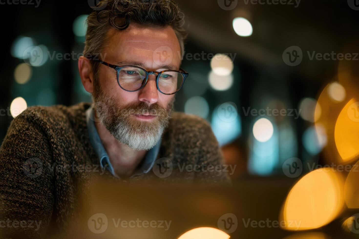 Man Using Laptop at Night in a Cafe Enjoying the Quiet Atmosphere photo