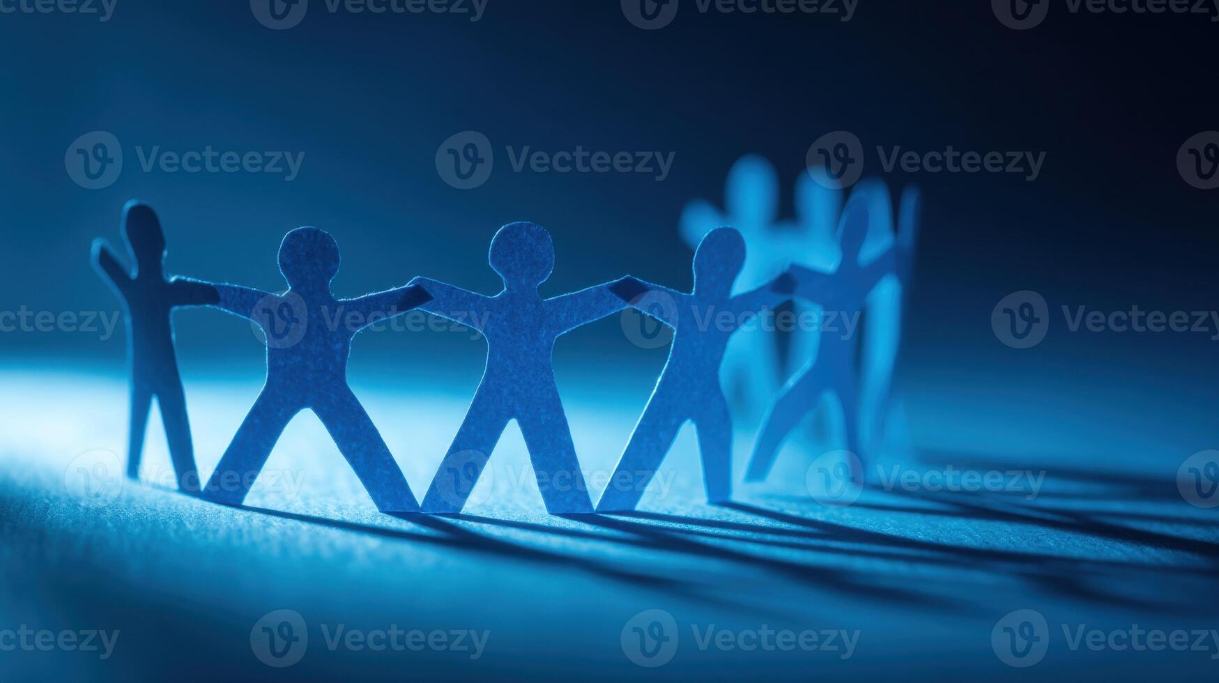 Paper Cutout Figures Holding Hands in a Circle Symbolizing Teamwork Success photo