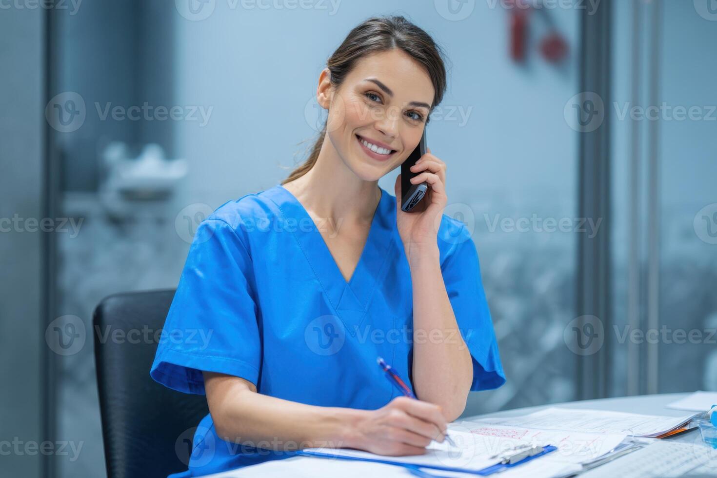 Professional Medical Staff Smiling While Talking on the Phone at Workplace photo