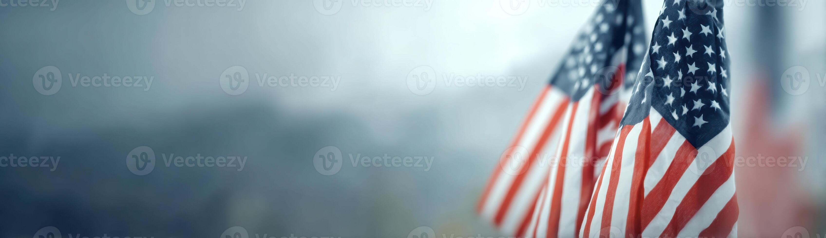 Two American Flags Stand Proudly Against a Pale Blue Gray Backdrop photo