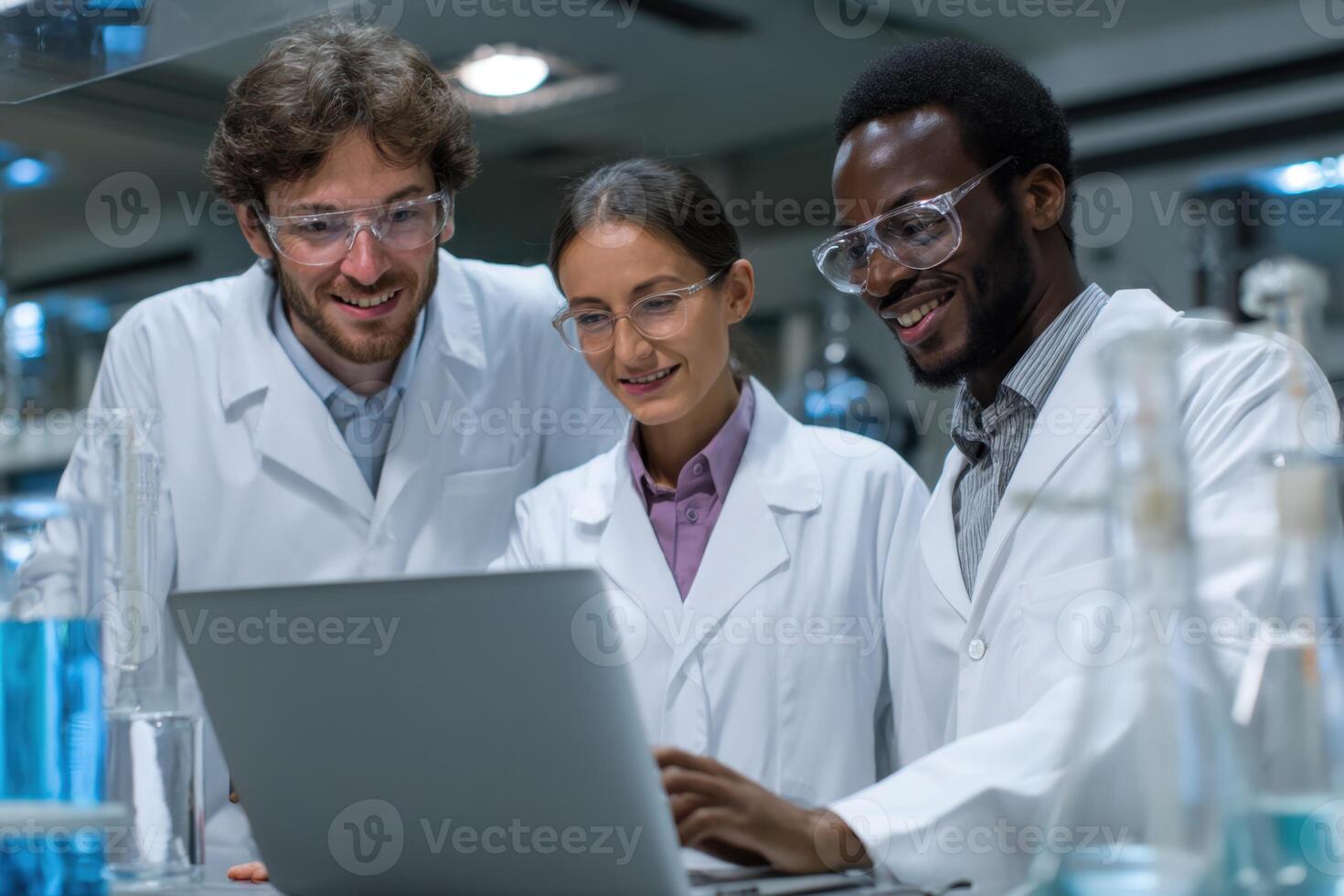 Three Scientists Collaborating on Research Project while Using a Laptop in Lab photo