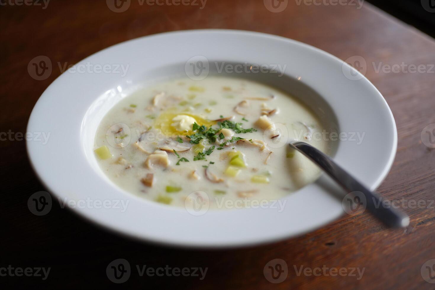 A bowl of soup with a spoon in it photo