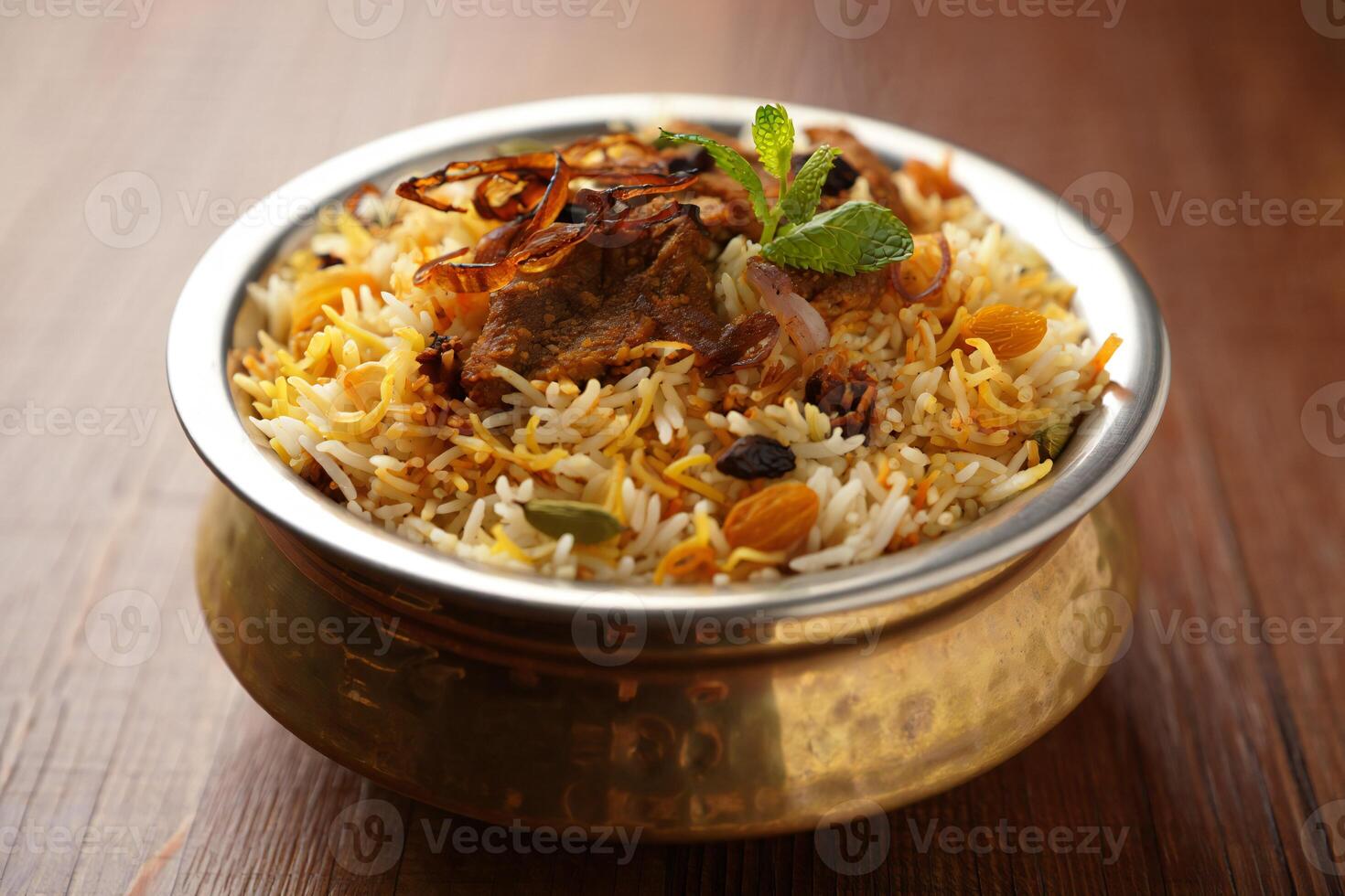 A bowl of rice and meat in a metal bowl photo
