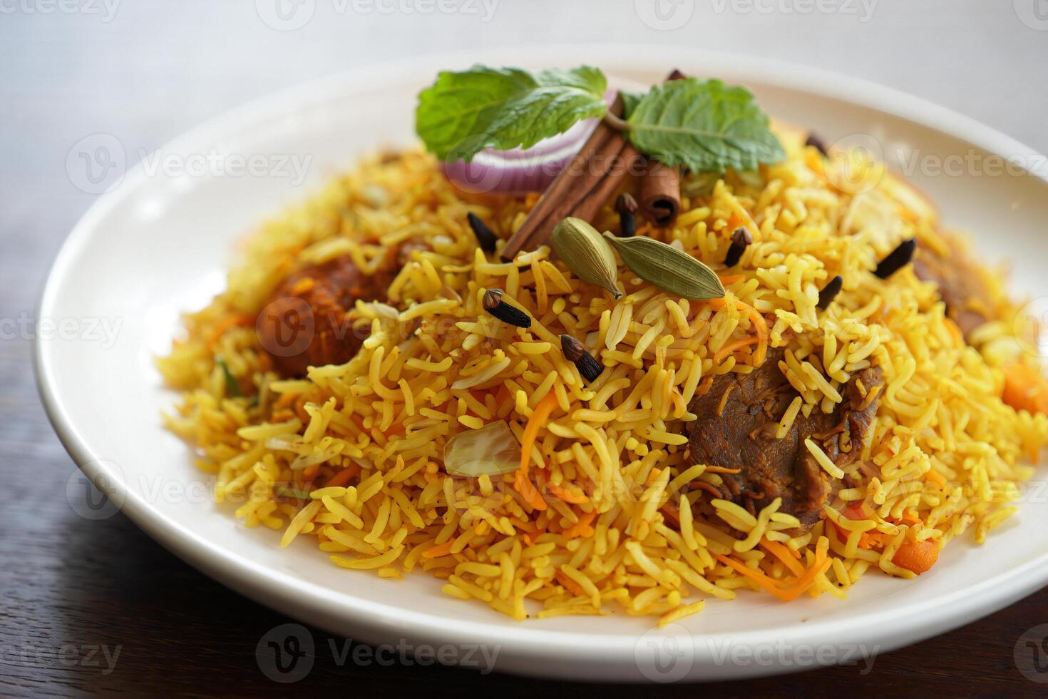 A plate of yellow rice with meat and spices photo