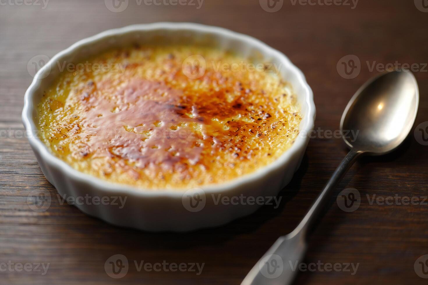 A bowl of food with a spoon sitting on a table photo