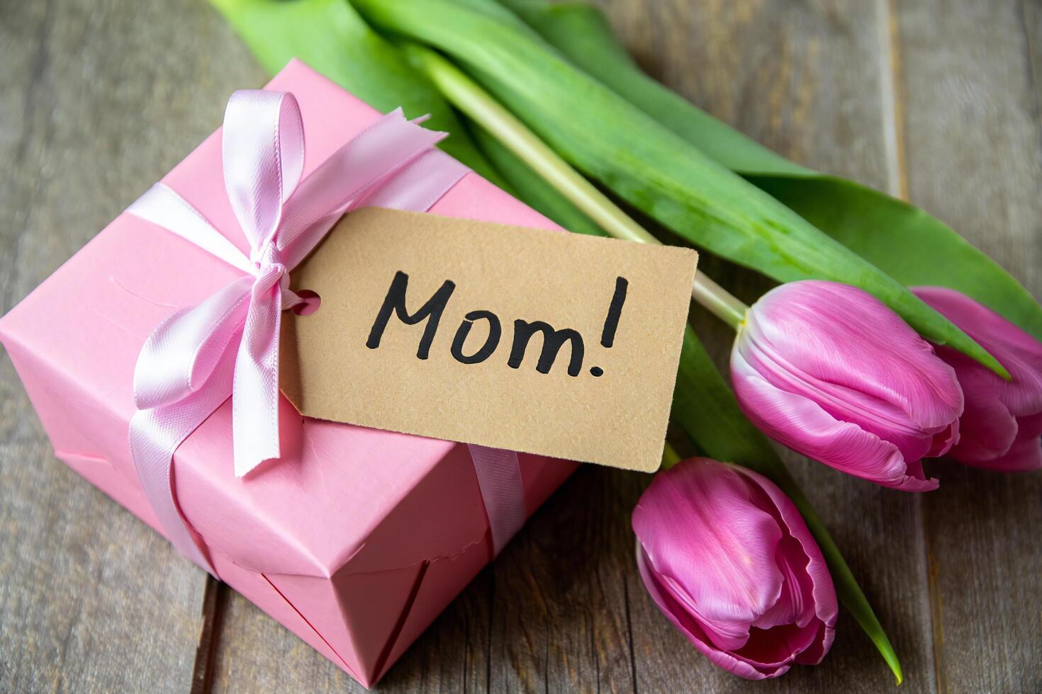 Flowers Background Pink Gift Box with Tulips and Mom Tag for Mother s Day Celebration photo