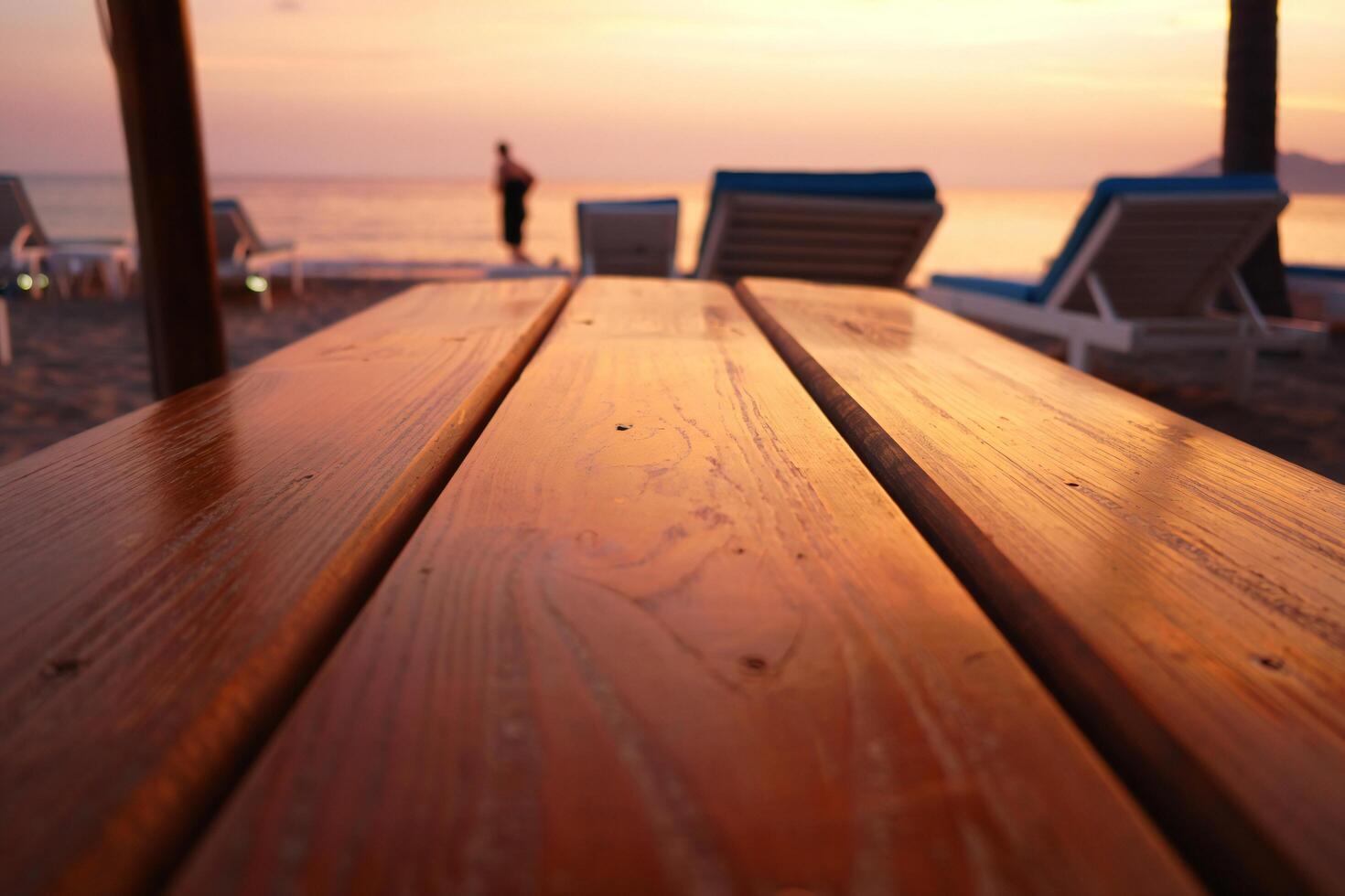 Beach Background Golden Sunset Beach Scene Wooden Table with Blurred Beach Chairs and Ocean View photo