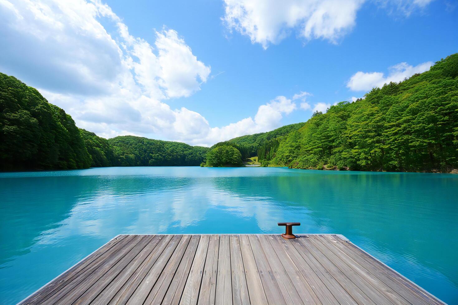 Beach Background Serene Lakeside Wooden Dock Turquoise Water Lush Green Hills Summer Day photo